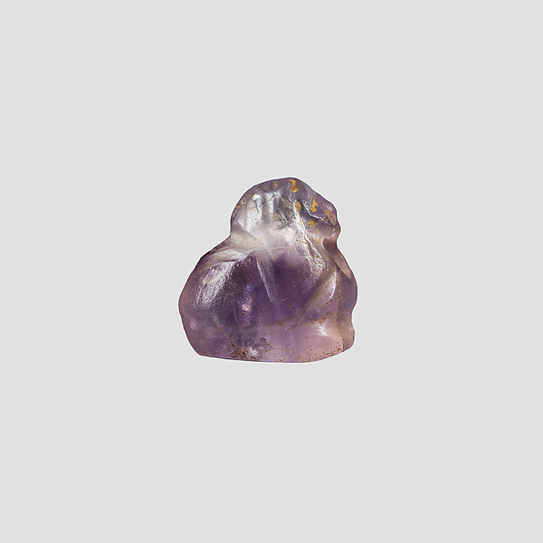 Human headed amulet (bird?)