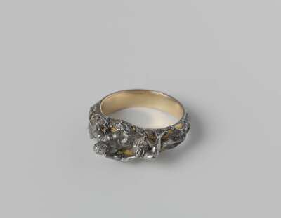 Ring with a reclining Vulcan
