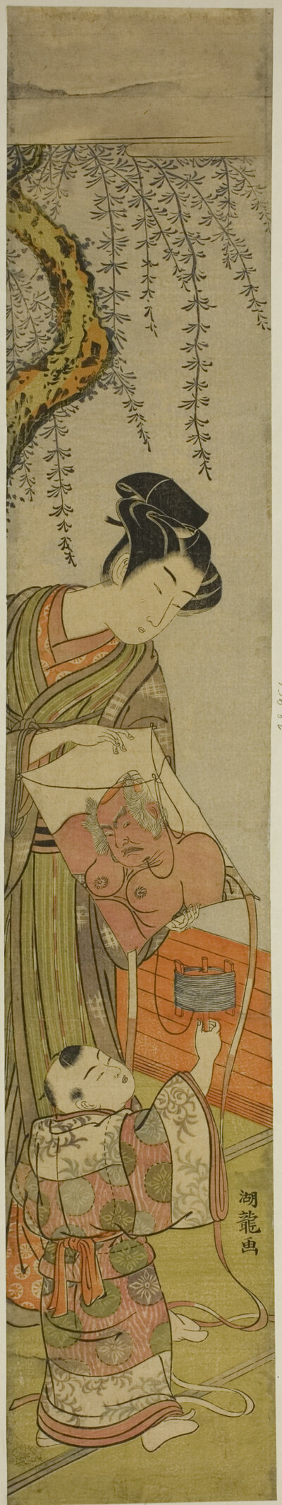 Young Man Holds a Kite for a Child